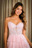 Woman wearing a pink lace dress against a neutral background