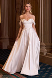 Woman in a white strapless gown standing in an elegant interior setting.