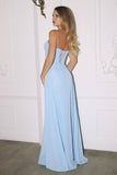 Woman wearing a light blue evening gown with a lace back against a white wall.