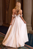 Woman in a white evening gown standing in an elegant interior setting