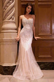 Woman in a beaded evening gown standing in an elegant interior setting.