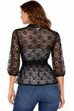 Woman wearing a black floral lace top with blue jeans on a white background